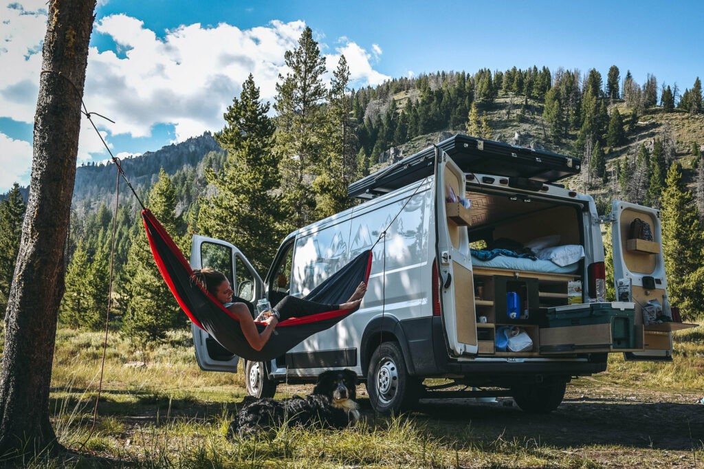 Relaxing in a hammock next to a campervan rental