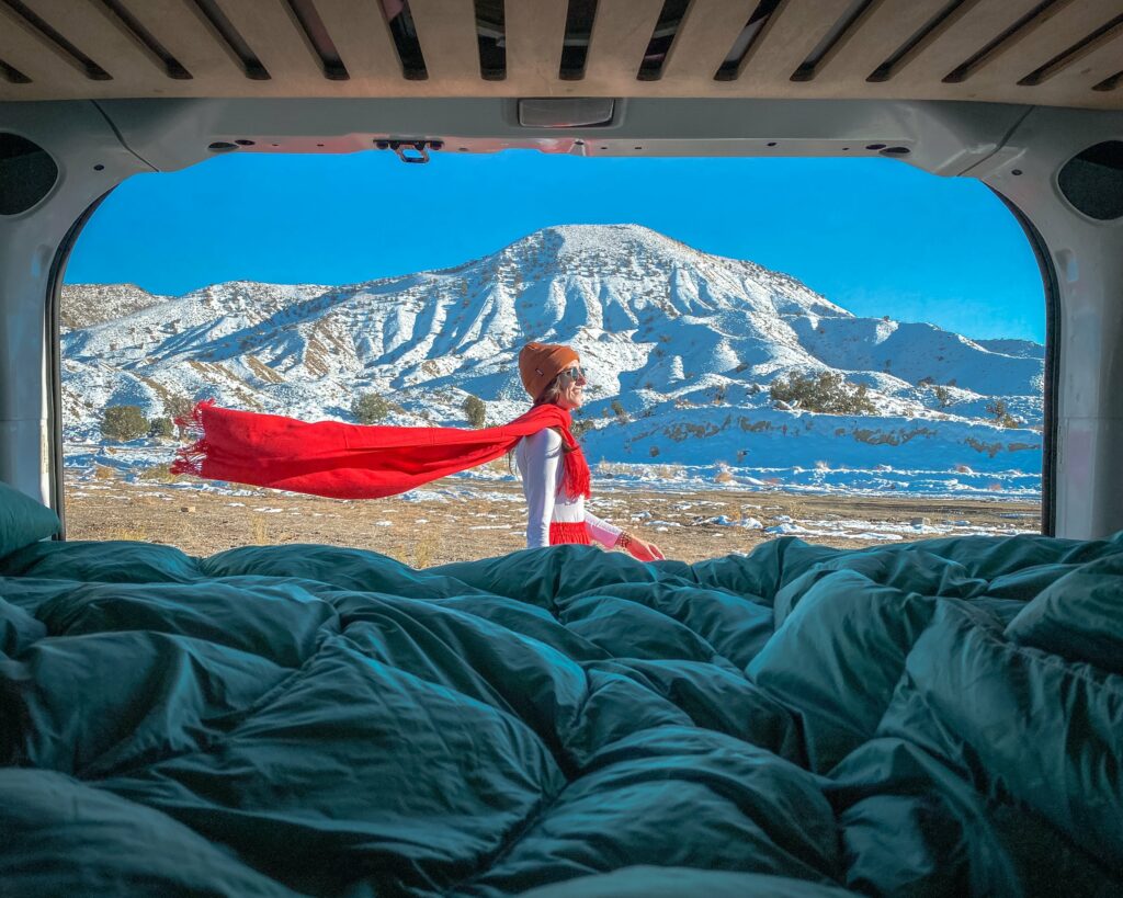 Woman with a red scarf taken from inside a campervan