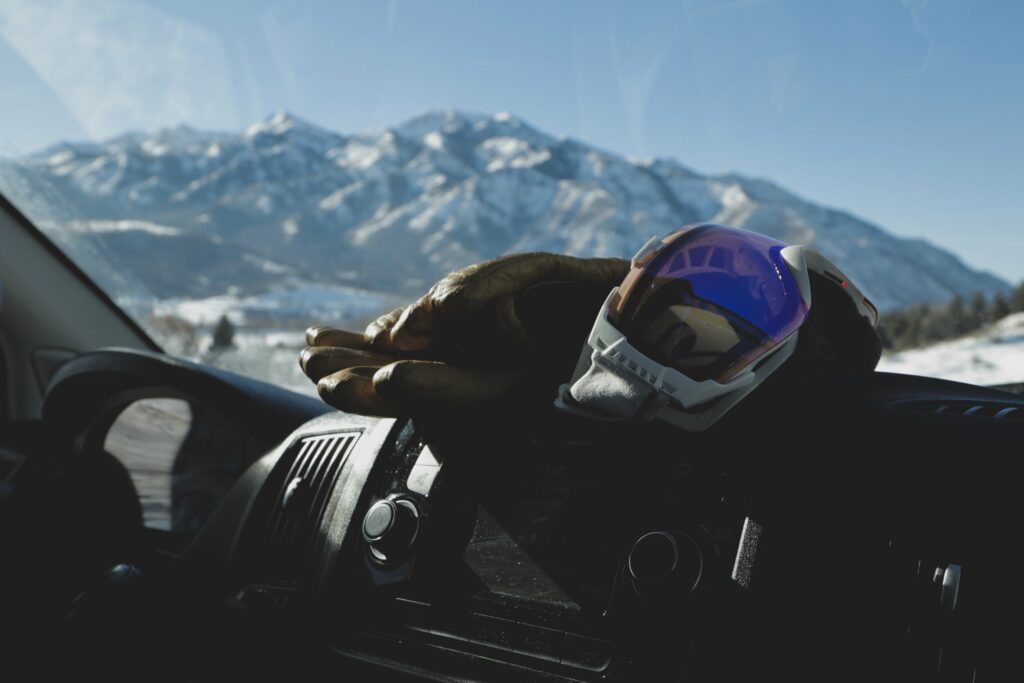 Goggles and Gloves with a ski resort in the background