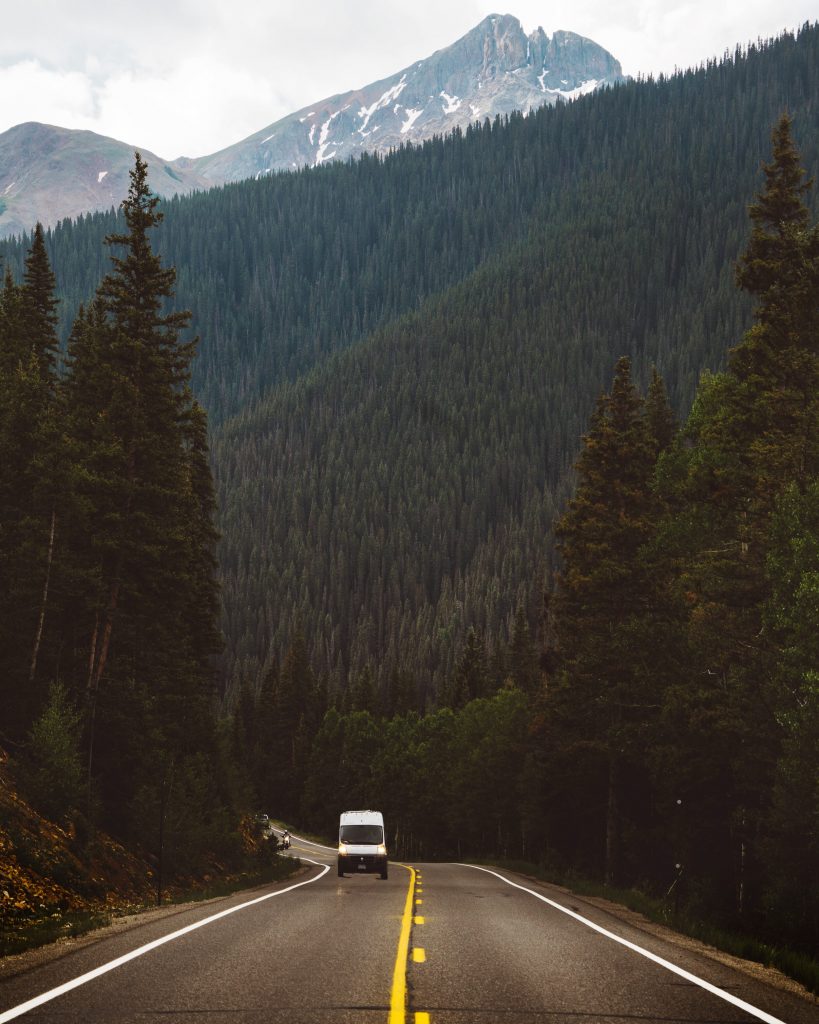 Campervan driving on a road towards Aspen