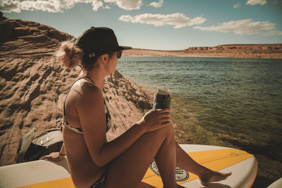 Woman sitting on a paddleboard looking at the lake