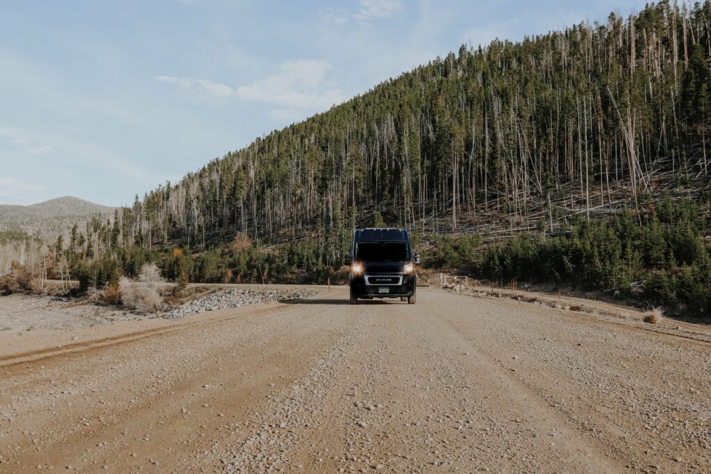 Campervan driving down a dirt road