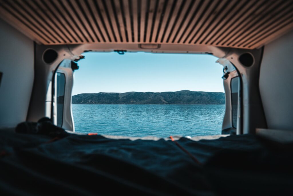 View of a lake from inside a Smalls Campervan