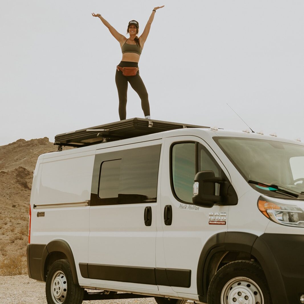 Woman standing on the top of a Campervan
