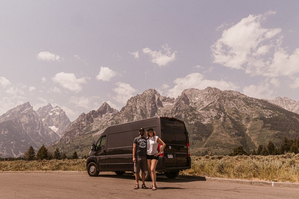 Couple posing in front of a Campervan at Grand Teton National Park