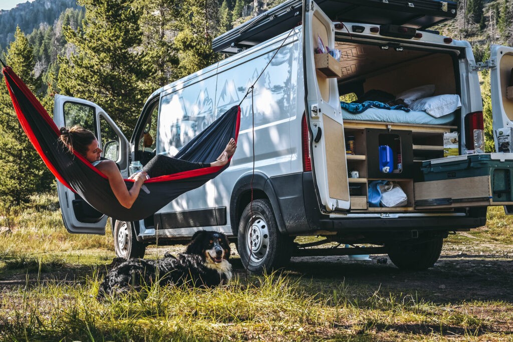 Chilling in a hammock by a camper van
