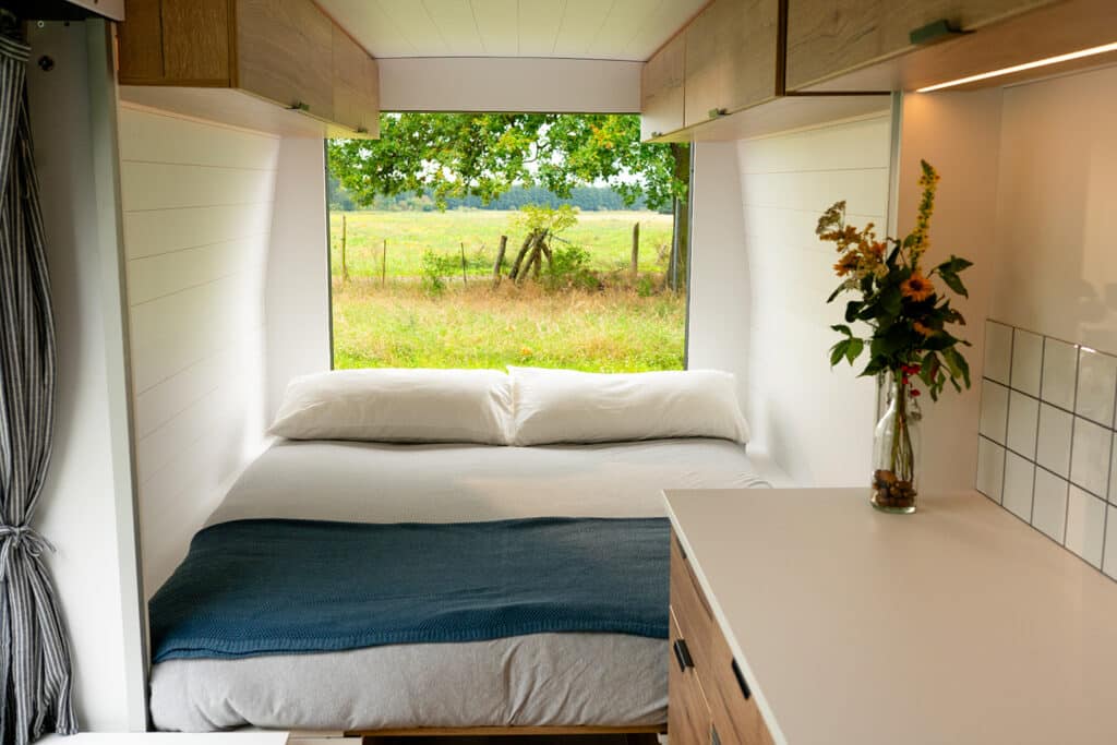 Queen bed setup in the Biggie Campervan