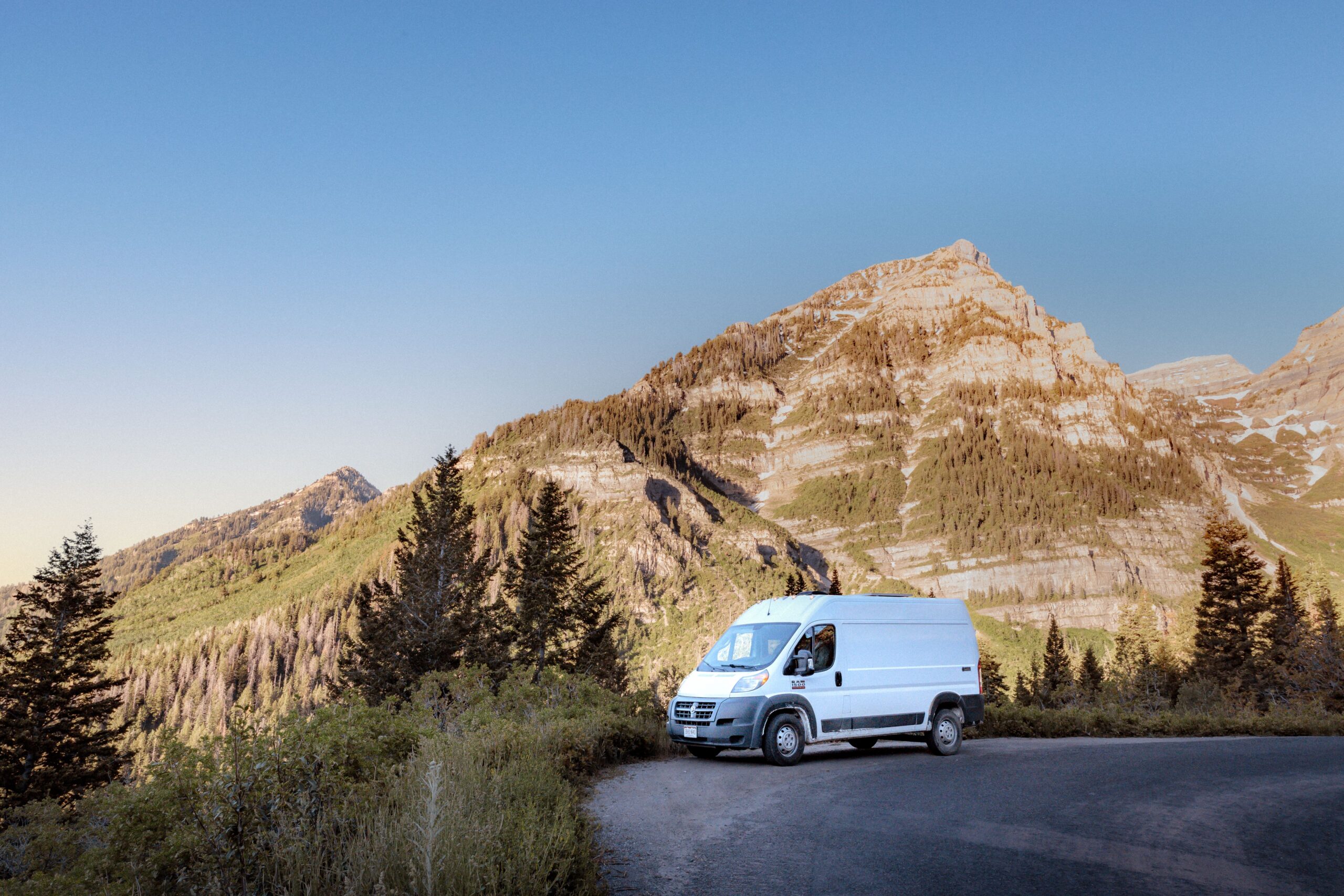 Biggie Campervan parked in the sunlight amongst the mountains