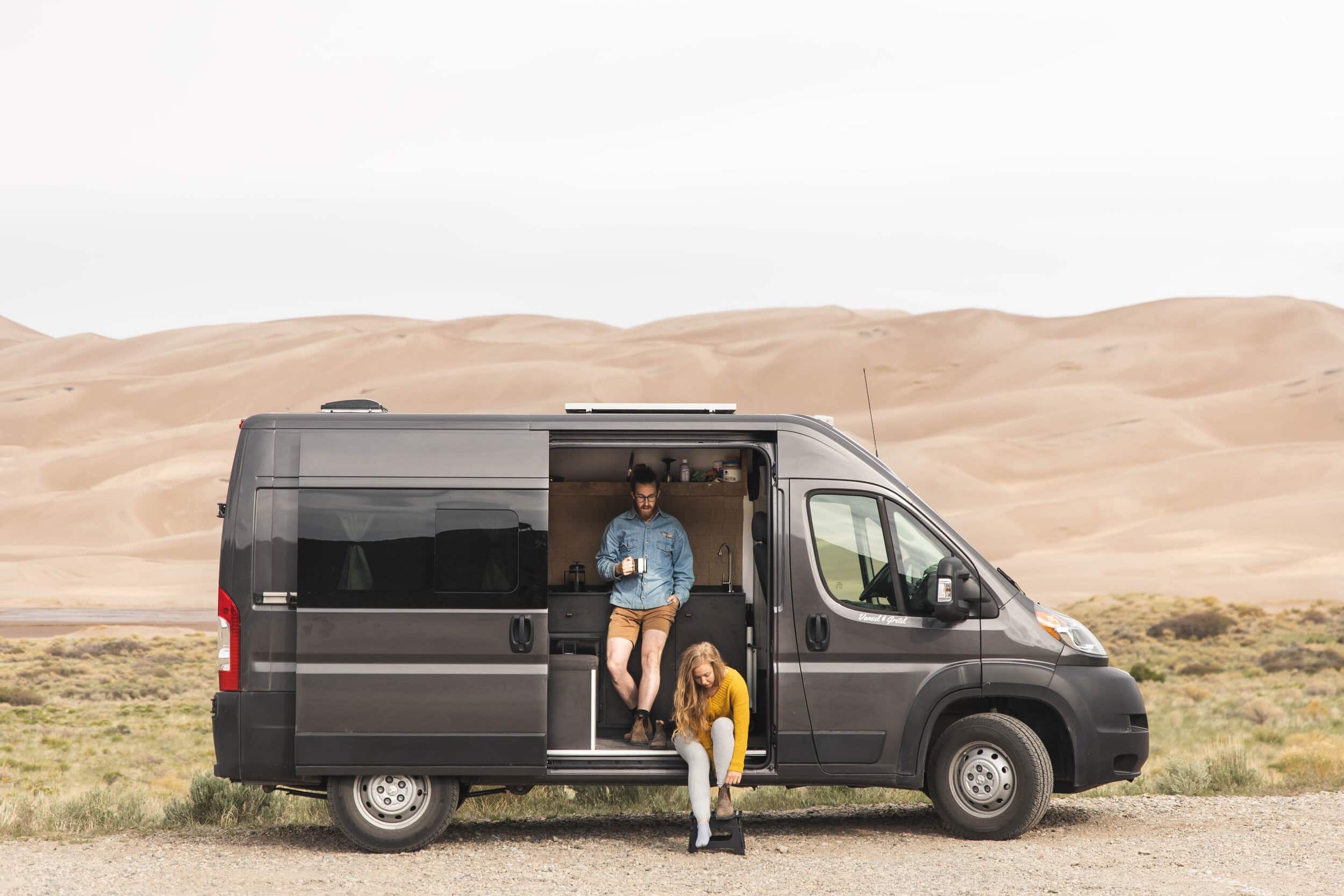 Couple sitting by a campervan in Great Sand Dunes National Park