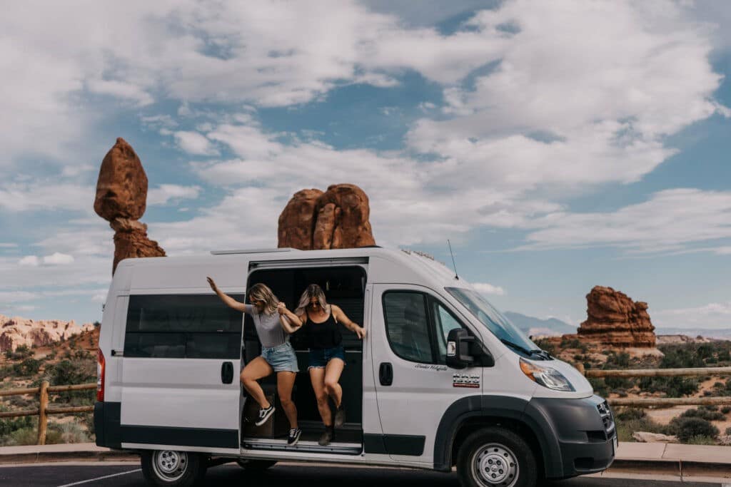 Jumping out of a van at Arches National Park