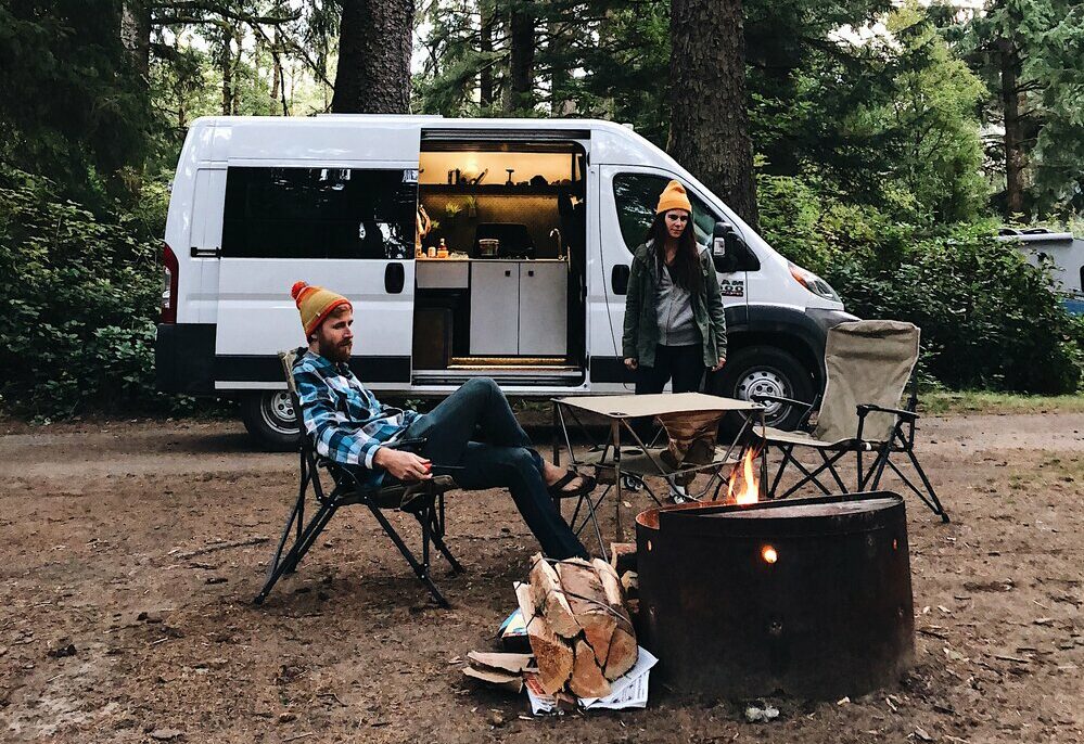 Couple hanging at a campsite with a campervan